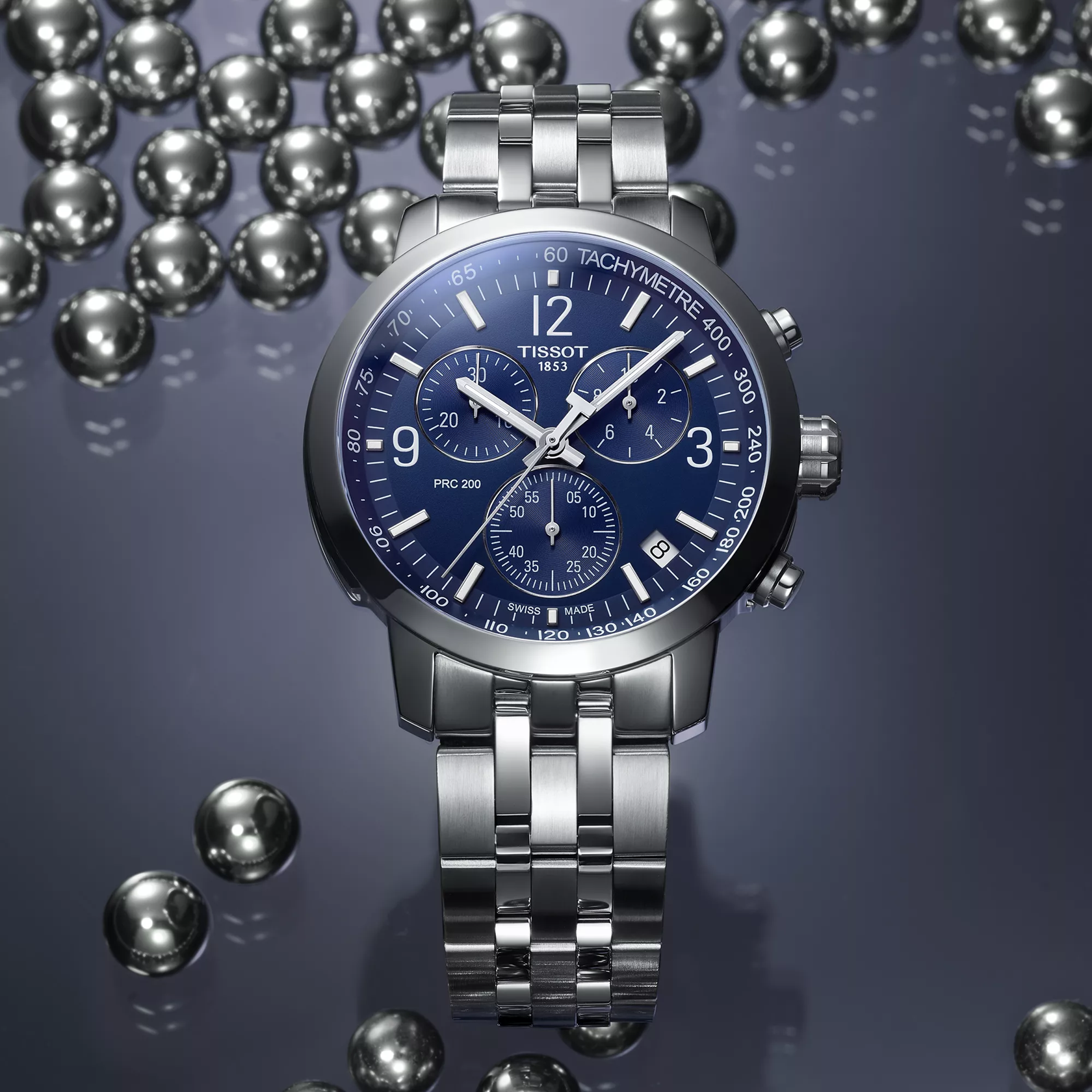티쏘 PRC 200 크로노그래프 watch on a colored background